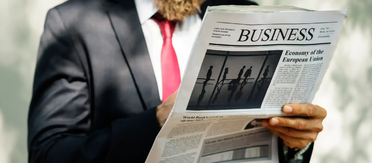 businessman-standing-reading-newspaper-1_11zon